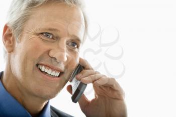 Royalty Free Photo of a Man Talking on a Cellphone and Smiling