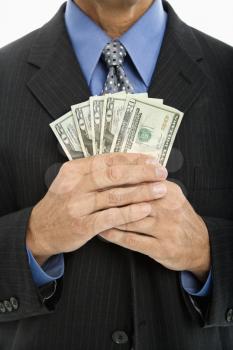 Royalty Free Photo of a Middle-Aged Businessman Holding a Handful of Cash