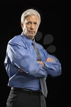 Royalty Free Photo of a Businessman Standing With Crossed Arms