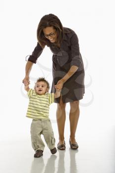 Royalty Free Photo of a Mother Teaching Her Toddler Son How to Walk