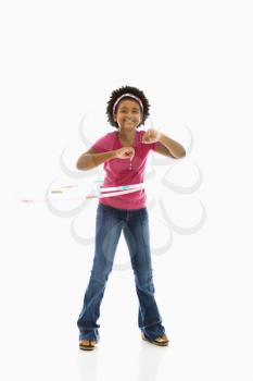 Royalty Free Photo of a Girl Playing With a Hula Hoop and Smiling