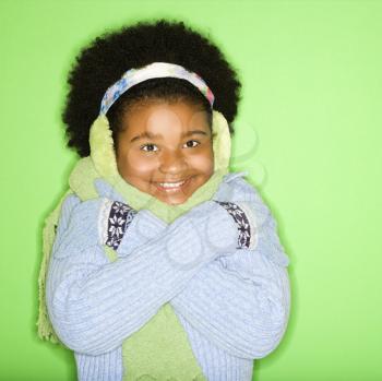 Royalty Free Photo of a Girl in Winter Clothing With Gloved Hands to Face Smiling