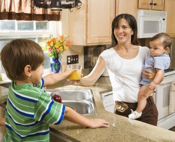 Royalty Free Photo of a Family in The Kitchen With Breakfast