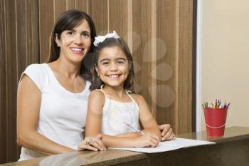 Royalty Free Photo of a Mother Helping Her Daughter With Homework