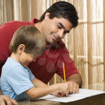 Royalty Free Photo of a Father Helping His Son with Homework