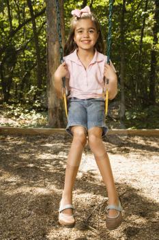 Royalty Free Photo of a Girl Sitting on a Swing
