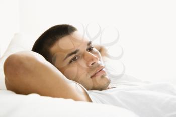 Royalty Free Photo of a Man Laying With His Arms Behind His Head