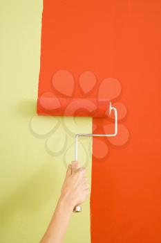 Royalty Free Photo of a Female Hand Painting a Wall