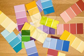 Royalty Free Photo of Paint Color Swatches Spread Out on a Wood Floor