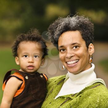 Royalty Free Photo of a Woman Holding a Toddler Boy and Smiling