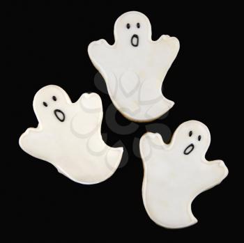Royalty Free Photo of Three Sugar Cookies in Shape of Ghosts with Decorative Icing