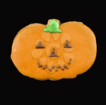 Royalty Free Photo of a Sugar Cookie in the Shape of a Pumpkin With Decorative Icing