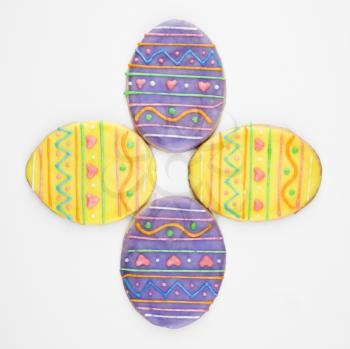 Four Easter egg sugar cookies with decorative icing.