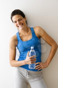 Royalty Free Photo of a Woman Holding a Water Bottle and Laughing