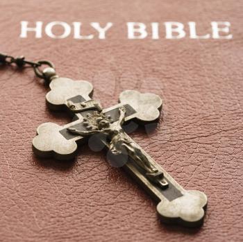 Royalty Free Photo of a Crucifix lying on cover of closed Holy Bible