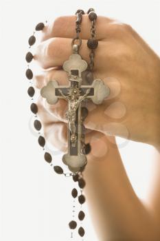 Royalty Free Photo of Woman's Hands Holding a Rosary With a Crucifix