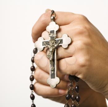 Royalty Free Photo of Woman's Hands Holding a Rosary With a Crucifix