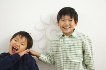 Royalty Free Photo of Two Young Brothers Playing and Laughing