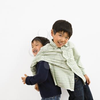 Royalty Free Photo of Two Young Brothers Playing and Laughing