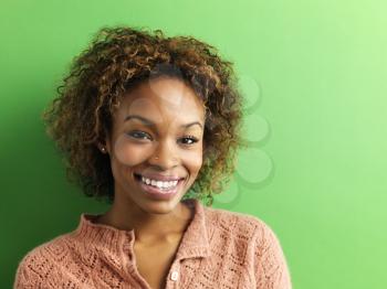Portrait of pretty young woman on green background.