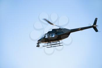 Royalty Free Photo of a Low Angle Shot of a Helicopter Flying Through the Sky