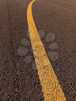 Royalty Free Photo of a Close-up of a Yellow Line on Asphalt