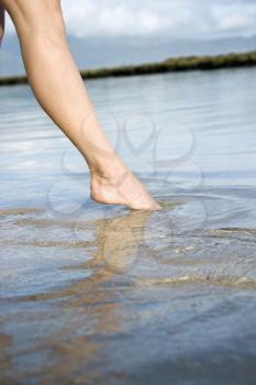 Royalty Free Photo of a Woman Dipping Her Toe in the Water to Test Temperature
