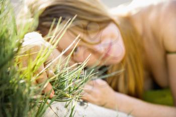 Royalty Free Photo of a Pretty Redheaded Woman Lying in Grass