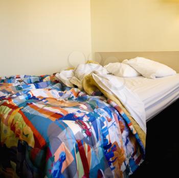Royalty Free Photo of a Motel Room With a Messy Unmade Bed