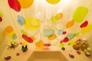 Royalty Free Photo of High Angle of a Polka Dotted Shower Curtain and Bathtub Toys