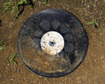 Royalty Free Photo of a Dirty 
Old Record Album on the Ground