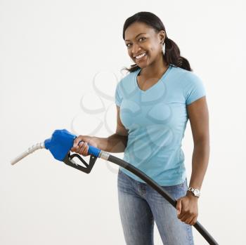Royalty Free Photo of a Woman Holding a Gas Pump and Smiling