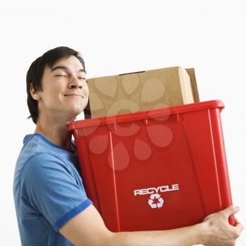 Royalty Free Photo of a Man Holding a Recycling Bin