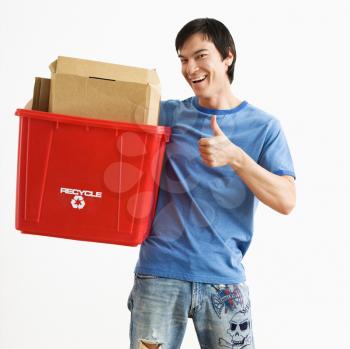Royalty Free Photo of a Smiling Man Holding a Recycling Bin