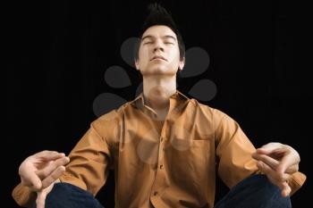 Royalty Free Photo of a Man Sitting in a Meditative Lotus Position