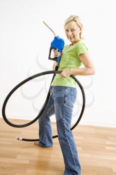 Royalty Free Photo of a Woman Holding a Gas Nozzle