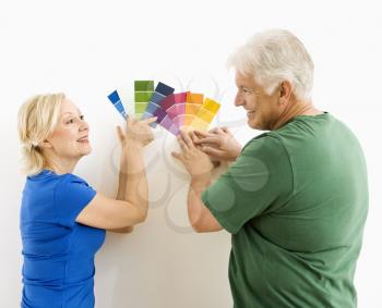Royalty Free Photo of a Middle-Aged Couple Comparing and Discussing Paint Swatches