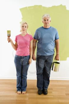 Royalty Free Photo of a Couple Standing With Paint Supplies 'American Gothic' Style