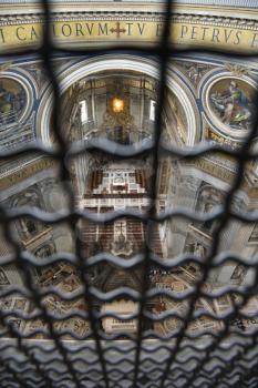 Altar in St Peter's Basilica seen through fencing. Vertical shot.