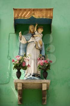 Low angle view of a shrine to Mary and Jesus. Vertical shot.