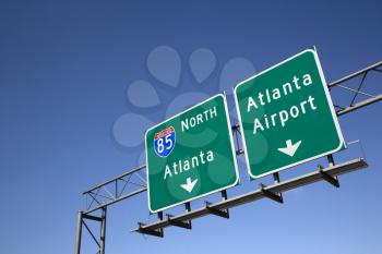 Freeway signs directing drivers to the Atlanta airport. Horizontal shot.
