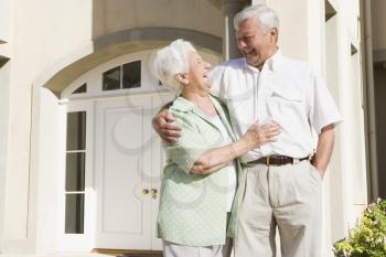Royalty Free Photo of a Senior Couple Outside Their Home
