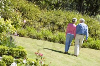 Royalty Free Photo of a Couple Walking in a Garden