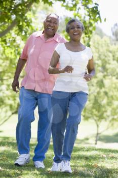 Royalty Free Photo of a Senior Couple Walking in a Park