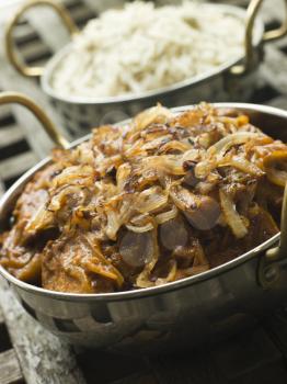 Royalty Free Photo of a Dish of Dopiaza Veal with Fragrant Pilau Rice