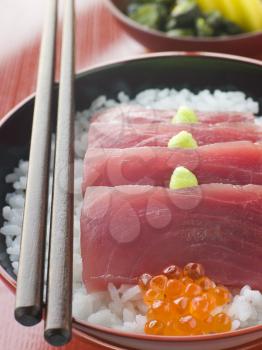 Royalty Free Photo of Sashimi of Yellow Fin Tuna on Rice with Salmon Roe Pickles and Wasabi