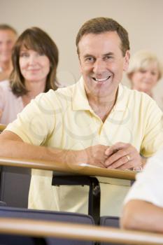 Royalty Free Photo of a Smiling Man in a Classroom