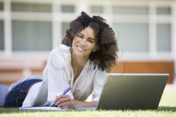 Royalty Free Photo of a Young Woman on the Lawn With a Laptop