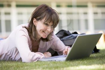 Royalty Free Photo of a Woman on the Lawn With a Laptop