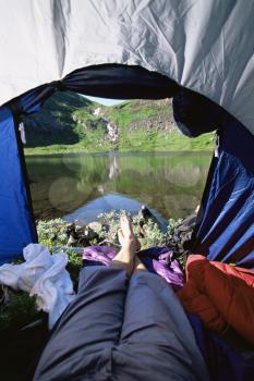 Royalty Free Photo of a Person's Legs in a Tent Overlooking Scenery